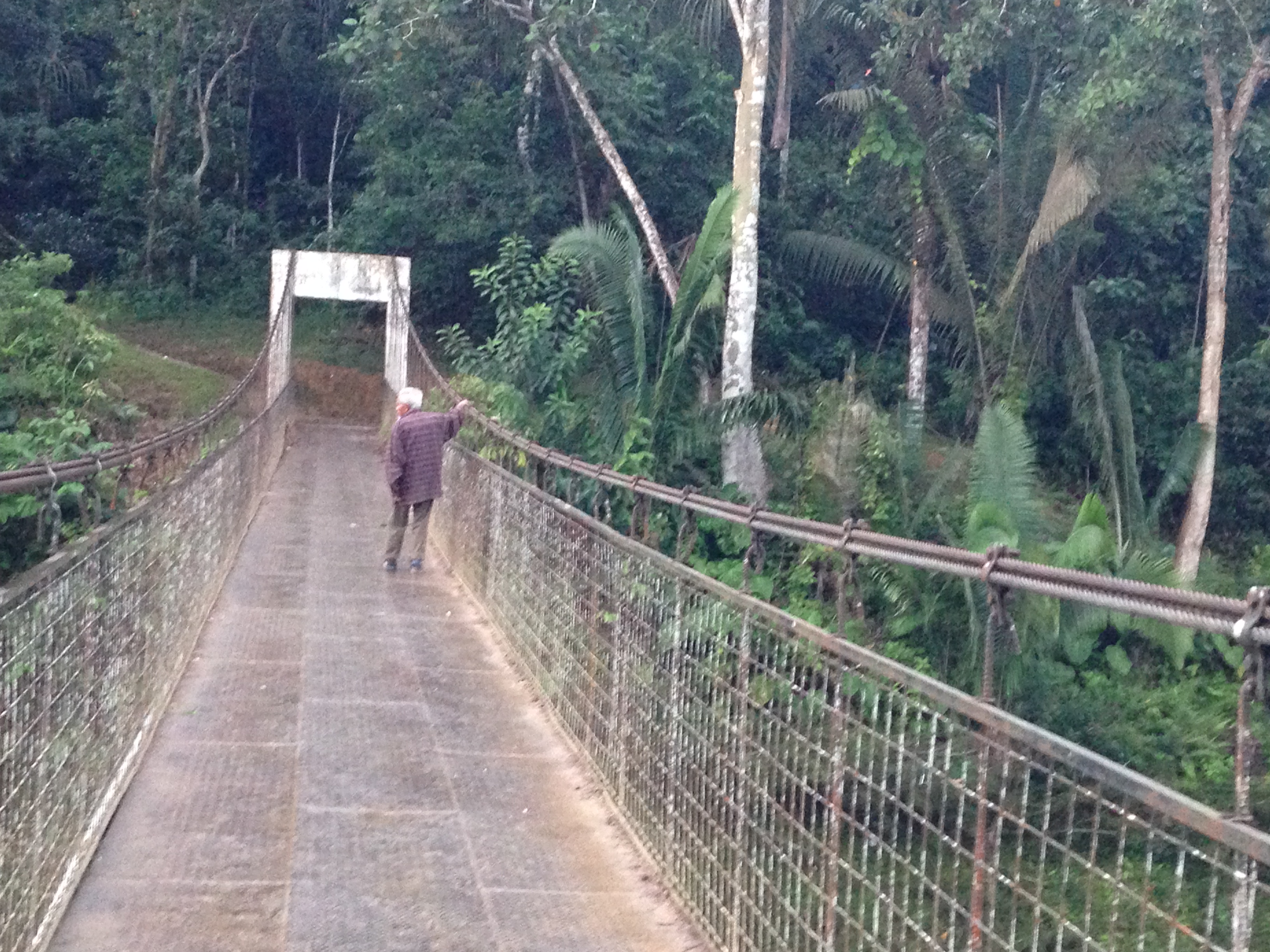 Sabino Gualinga crosses Sarayaku bridge