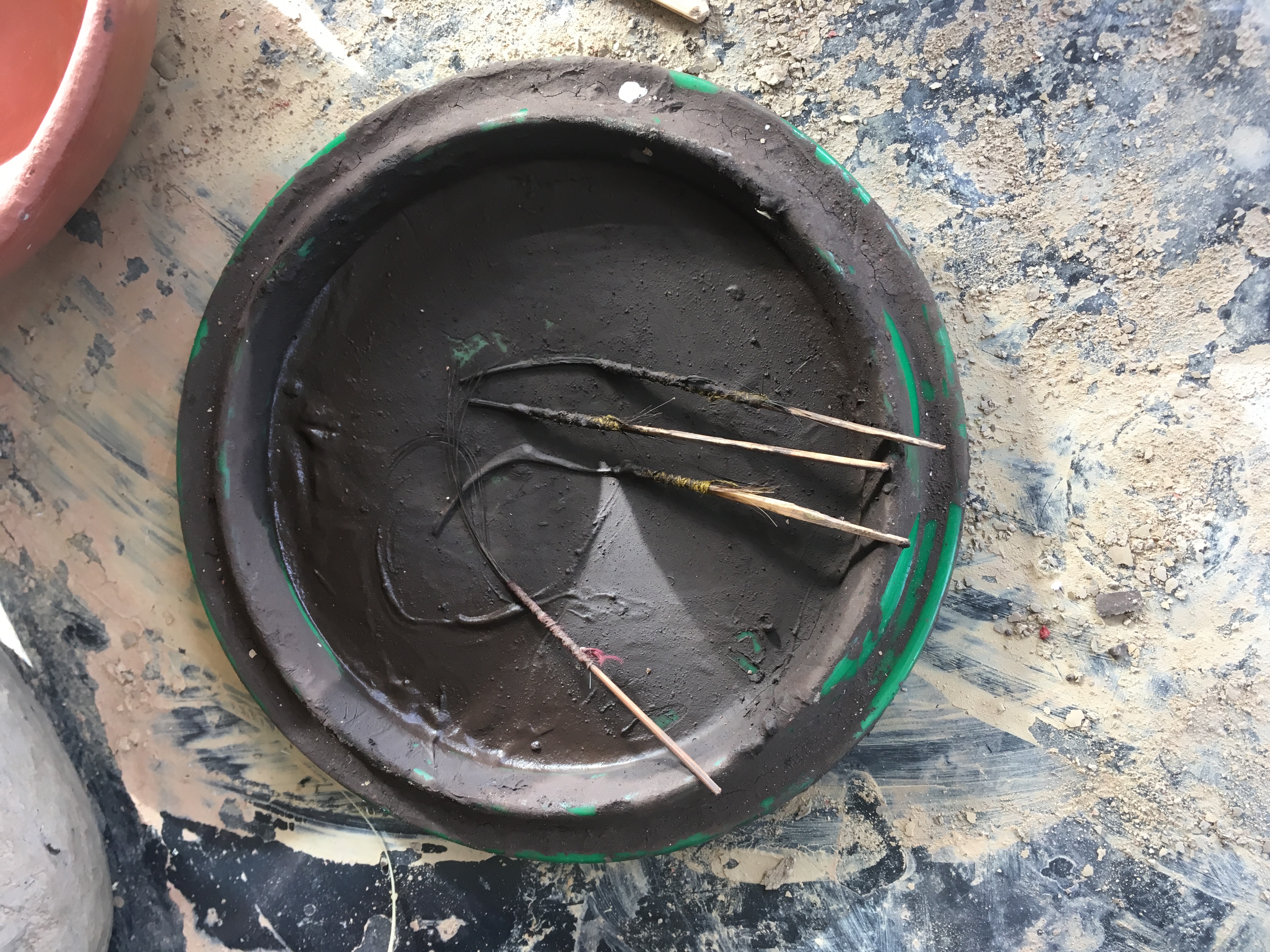 Paint brushes in black pigment